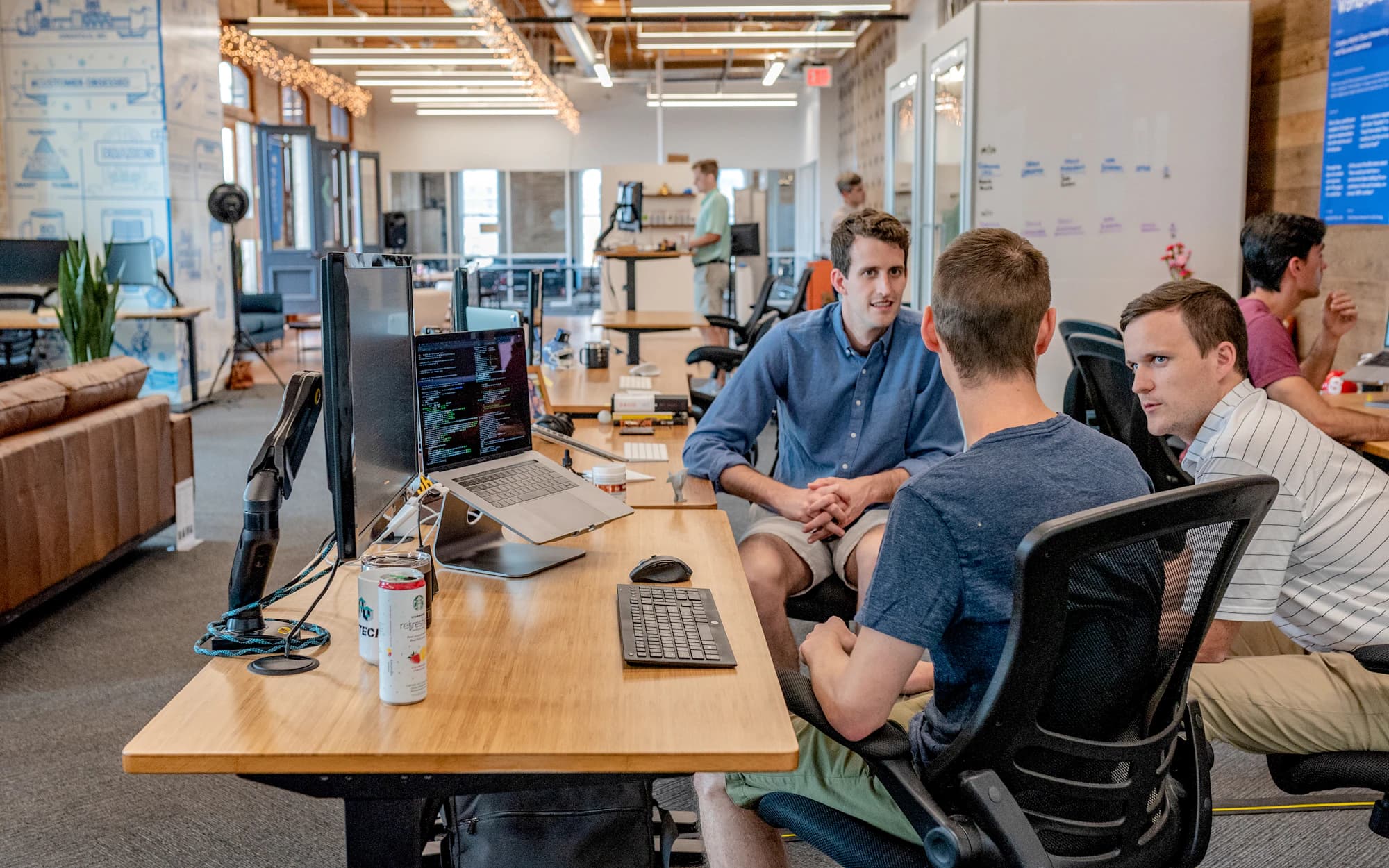 A support team coordinating the working day in an open office
